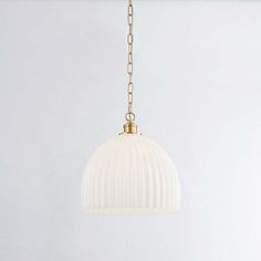 a white light hanging from a gold chain