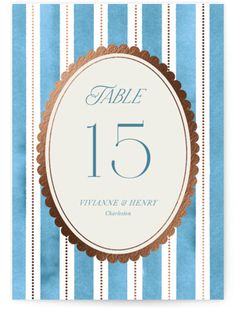 a blue and white striped table card with the number fifteen on it's front