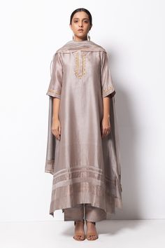 Silver grey kurta highlighted with zardozi embroidery, round neckline and straight silhouette. Comes with cotton silk pant, chanderi dupatta and inner slip.
Component: 4
Pattern: Embroidered
Type Of Work: Zardozi
Neckline: Round
Sleeve Type: Three Quarter
Fabric: Kurta: Handwoven Chanderi Silk; Dupatta: Chanderi; Pant: Cotton Silk
Color: Grey
Other Details: 
Straight kurta
Concealed placket
Side pockets
Asymmetric hem
Contrast hem pant
Dupatta with tassels
Occasion: Mehendi and Haldi, Puja - Aza Chanderi Suits Design, Suits For Women Indian, Grey Kurta, Silk Kurta Set, Indian Designer Suits, A Line Kurta, Silk Kurta, Suits Design, Silk Suit