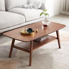 a coffee table sitting on top of a rug next to a couch