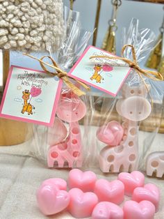 some pink and white candy hearts are on a table next to a card with a giraffe