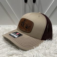 Introducing Our Laser Engraved Patch Hats, Now Available On The Renowned Richardson 112 Caps. These Premium Hats Combine The Best Of Both Worlds - The Trusted Richardson Quality And Our Exclusive Laser-Engraved Patches. Mens/Womens One Size *Patch Is Overlay For Demonstrative Purposes Only. The Actual Hat Will Be Press Heated. Western Brown Trucker Hat With Flat Bill, Brown Western Trucker Hat With Flat Brim, Country Style Brown Baseball Cap With Flat Brim, Western Style Brown Trucker Hat With Flat Bill, Brown Country Style Baseball Cap With Curved Brim, Brown Baseball Cap For Rodeo, Brown Snapback Baseball Cap For Rodeo, Brown Snapback Cap For Rodeo, Brown Snapback Hat For Rodeo