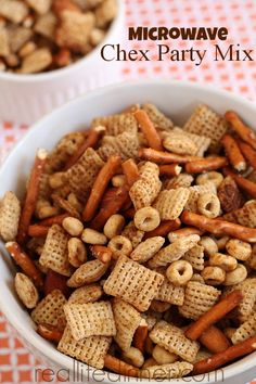 two bowls filled with chex party mix on top of a checkered table cloth