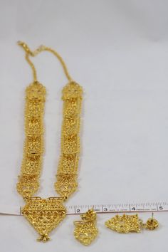 Thank you for looking at this listing! Up for sale is: Gold Tone Filigree Exotic Ethnic Asian Eastern Indian Dangle Chunky Necklace Chandelier Earrings Parure Set Used, please see pictures for details on condition. I'm not an expert in rating condition, so please look carefully at the pictures and ask questions. What you see is what you get, sold As-Is. Shipping only within the United States. If you win multiple listings, I can combine shipping costs as long as items are paid for within 5 days o Gold Chandbali Bridal Necklace In Bohemian Style, Gold Bohemian Bridal Necklace With Latkans, Traditional Gold Bridal Necklace With Dangling Beads, Bohemian Gold Bridal Necklace For Ceremonial Occasions, Necklace Chandelier, Blue Quartz, Chunky Necklace, Quartz Ring, Black Enamel