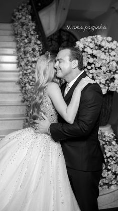 a man in a tuxedo kissing a woman in a ballgown dress