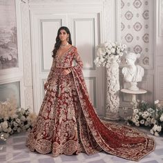 a woman in a red and gold wedding dress