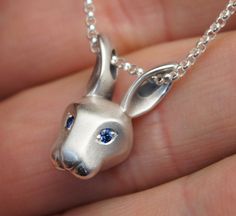 silver bunny pendant  pick your eye color by Michaeltatom on Etsy SOOOOO Cute! I love this! and love you can pick your own eye  color! And the chain goes through the ears! Wish I had one! Equestrian Necklace, Rabbit Jewelry, Horseshoe Jewelry, Horse Bracelet, Rabbit Pendant, Fox Pendant, Rabbit Necklaces, Horse Earrings, Equestrian Jewelry