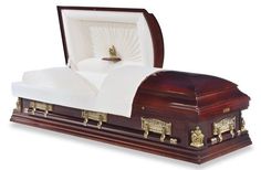 a wooden casket with white sheets and gold decorations