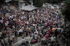 a large group of people standing around in the street