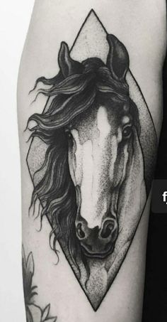 a black and white horse tattoo on the arm