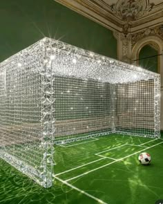 a soccer ball sits in the middle of a room that is made out of crystal cubes