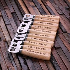 four bottle openers with the words do crew engraved on them