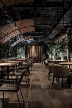 an empty restaurant with wooden tables and chairs