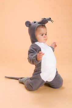 a baby is dressed up in a mouse costume