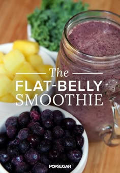 the flat belly smoothie is in a mason jar next to blueberries and pineapples