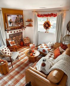 a living room filled with furniture and a fire place covered in pumpkins next to a window