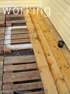 the words working are overlaided with images of wood pallets in front of a house