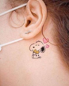 a woman with a small tattoo on her back neck and behind the ear is a heart