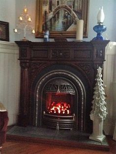 a living room with a fire place and pictures on the wall