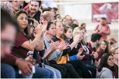 many people are sitting and clapping together