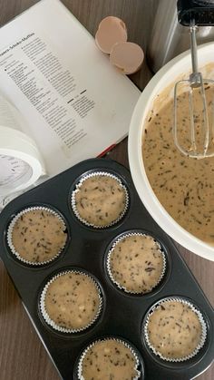 muffin batter in a cupcake pan with an open book