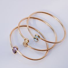 Designed for any occasion, our Amaia bangle is a piece you'll want to use forever! Precious Metal: 14K Yellow Gold Diameter: 7” adjustable up to 9” (56 x 64mm) Stones: Cubic Zirconia Stones size: 8.7mm Colors: Blue, Yellow or Purple Sold individually. Picture for illustrative purposes only. Comes in our beautiful gift box ***Note: Prices and availability are subject to change without notice. Follow us on Instagram Don't know your bracelet size? Download and print our "Wrist Measuring Tool" ***ma Metal Bangles, Dad Jewelry, Mini Necklace, Piercing Ring, Stone Bangle, Custom Earrings, September Birthstone, August Birth Stone, Precious Metal