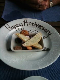 a white plate topped with bread and other food