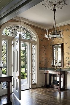 an image of a room with french doors and chandelier