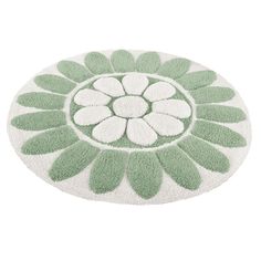 a green and white rug with flowers on it