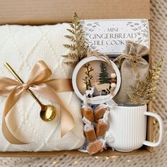 a gift box with coffee, cookies and other items in it that include a mug