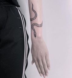 a person with a snake tattoo on their arm