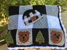 there is a crocheted blanket with bears on it and a teddy bear hat