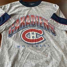 "Title: Habs T-shirt Size: Small Made in: Canada Material: Cotton Pit to pit: 18\" Length: 25\"" Graphic Tee With Team Logo In Tri-blend Fabric, Graphic Tee With Team Logo In Tri-blend, Tri-blend Graphic Tee With Team Logo, Graphic Tee With Team Logo And Crew Neck, Graphic Tee For Sports Season, Sports Season Text Print Crew Neck T-shirt, Sports Season Graphic Print Crew Neck Shirt, Sports Season Graphic Tee With Crew Neck, Montreal Canadiens