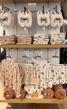 baby clothes are on display in a store