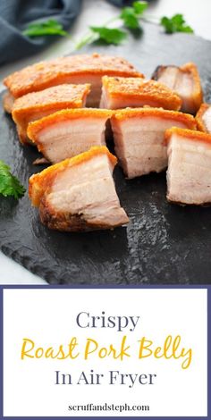 crispy roast pork belly in air fry on a black slate platter with parsley