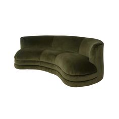 the curved sofa is made from green velvet