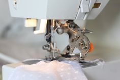 the sewing machine is being used to sew fabric on it's sides,