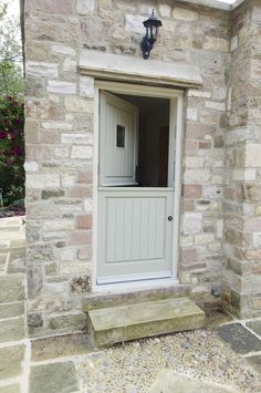 an open door to a brick building with stone steps