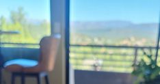 a blurry photo of a chair and table in front of a sliding glass door