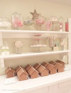 shelves filled with candy and candies on top of white counter tops in a kitchen