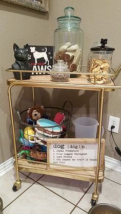 a shelf filled with lots of toys and knick - knacks on top of a tiled floor