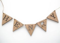 a wooden banner with letters hanging from it's sides and the words happy new year written on them