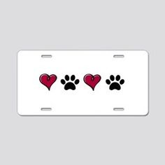 three hearts and paw prints on a white license plate