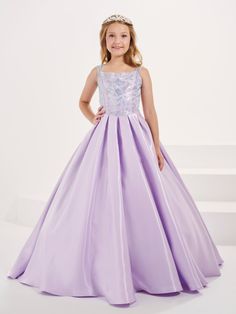 Your sweet girl will love twirling around in this beaded long sleeveless dress with A-line satin skirt by Tiffany Princess 13697. This sleeveless gown features a square neckline with heat-set AB stone bodice, sheer straps, floor length A-line box pleated skirt, sweep train, and a lace-up keyhole back. House of Wu Tiffany Princess Collection Spring 2023 Style Number: 13697 Fabric: Shimmer Satin/Beaded Embellishments Colors: Hunter Green, Lilac Sizes: 2, 4, 6, 8, 10, 12, 14, 16 Occasions: Pageant, Ball Gown Dresses With Sweep Train For Pageant, Sweep Train Dress For Pageant During Prom Season, Elegant A-line Pageant Dress, Princess Evening Dress With Fitted Bodice For Pageant, Princess Style Sleeveless Evening Ball Gown, Princess Style Evening Dress With Fitted Bodice For Pageants, Princess Style Sleeveless Prom Gown, Princess Style Sleeveless Gown For Prom, Princess Style Sleeveless Dress For Debutante Ball