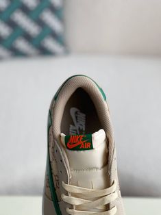 Embrace the ultimate fusion of streetwear and luxury with these Air Jordan 1 Low-inspired sneakers, customized with Gucci flair. The earthy brown and sail colorway, reminiscent of the coveted Travis Scott collaboration, is elevated with the iconic Gucci monogram subtly incorporated into the design. The reversed Swoosh and green accents add a playful touch, while the premium materials and meticulous craftsmanship ensure a comfortable and stylish experience. Step out in a pair that's truly one-of- Beige Low-top Custom Sneakers With Speckled Midsole, Beige Custom Sneakers With Gum Sole For Streetwear, Luxury Green Sneakers For Streetwear, Luxury Cream Sneakers For Streetwear, Luxury Streetwear Sneakers With Gum Sole, Sneakers Customized, Nike Brown, Fall Winter Jacket, Earthy Brown