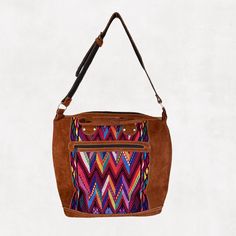 Our eco-friendly weekender bag is made with a stunning repurposed handwoven huipil (Guatemalan blouse) exterior with a black cotton lining. One exterior and one interior pocket plus an adjustable suede shoulder strap.It is a stylish way to pack for a quick weekend get-away. Product Dimensions: 25.5" W x 17" H x 8" D. Double handles measures approx 20" with 2" drop.adjustable suede shoulder strap. Handwoven Hobo Shoulder Bag For Everyday, Bohemian Tote Shoulder Bag With Zipper Pocket, Bohemian Brown Shoulder Bag With Zipper Pocket, Bohemian Shoulder Bag With Leather Trim For Everyday Use, Bohemian Shoulder Bag With Leather Trim, Bohemian Tote Shoulder Bag With Leather Trim, Weekender Bag, Leather Tote, Black Cotton