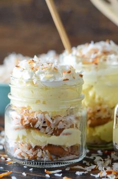 two jars filled with desserts sitting on top of a table