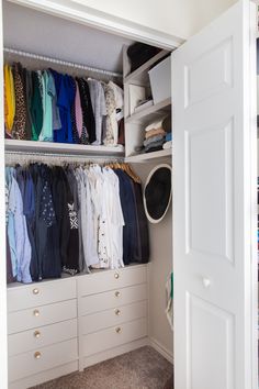 an organized closet with white drawers and clothes hanging on the wall, along with several pairs of shoes