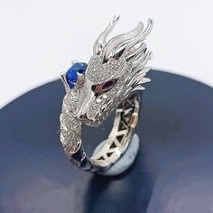 🎁Don't forget to buy some for your family or friends as it's an unique gift idea.❤️Dragon is a symbol of wealth and good luck 🐉💸 Give this beautiful dragon ring to your beloved and wish her/him all the best 💝💝.This is a stunning handmade piece of work where every detail is scrutinized.As a result, our dragon is finely modeled with an unmistakable pattern of dragon scales. Everyone will be fascinated by our dragon ring, which will add to the mystique of the person who wears it.Elevate your s Round Dragon Design Jewelry For Gifts, Dragon Design Jewelry For Gift, Dragon Design Jewelry Gift, Collectible Dragon Design Jewelry Ring, Collectible Dragon Design Ring, Dragon Design Ring Jewelry For Gift, Dragon Design Ring Jewelry Gift, Dragon Design Anniversary Ring Jewelry, Anniversary Dragon Design Ring