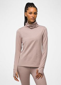 A turtleneck with a cozy brushed interior made for moving outdoors on cold days. Winter Funnel Neck Turtleneck With Thumbholes, Winter Turtleneck With Thumbholes And Funnel Neck, Heather Athleisure Top For Fall, Versatile Fall Outdoor Tops, Sporty Turtleneck Top For Fall, Versatile Outdoor Winter Tops, Winter Funnel Neck Top For Outdoor, Winter Sporty Turtleneck Tops, Heather Winter Tops For Loungewear